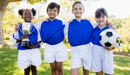 Jeunes footballeurs tenant une couope